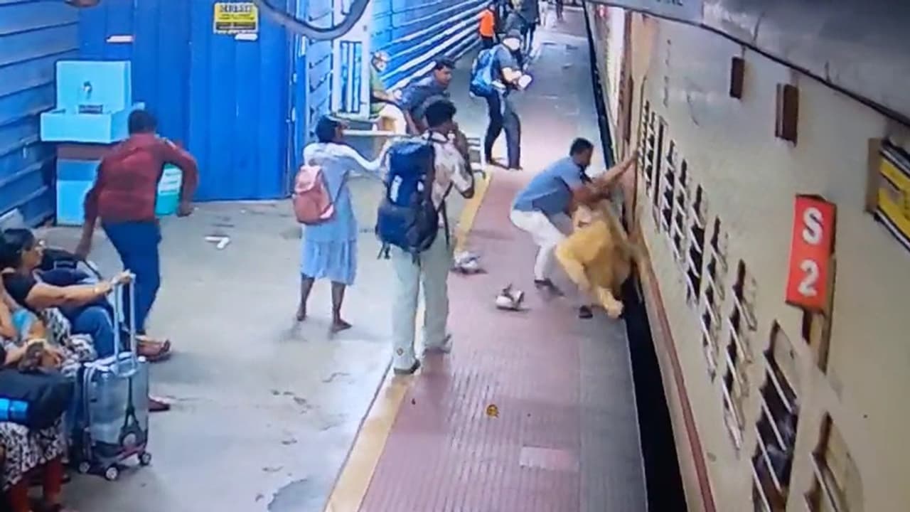 Railway staff saves woman from falling under train