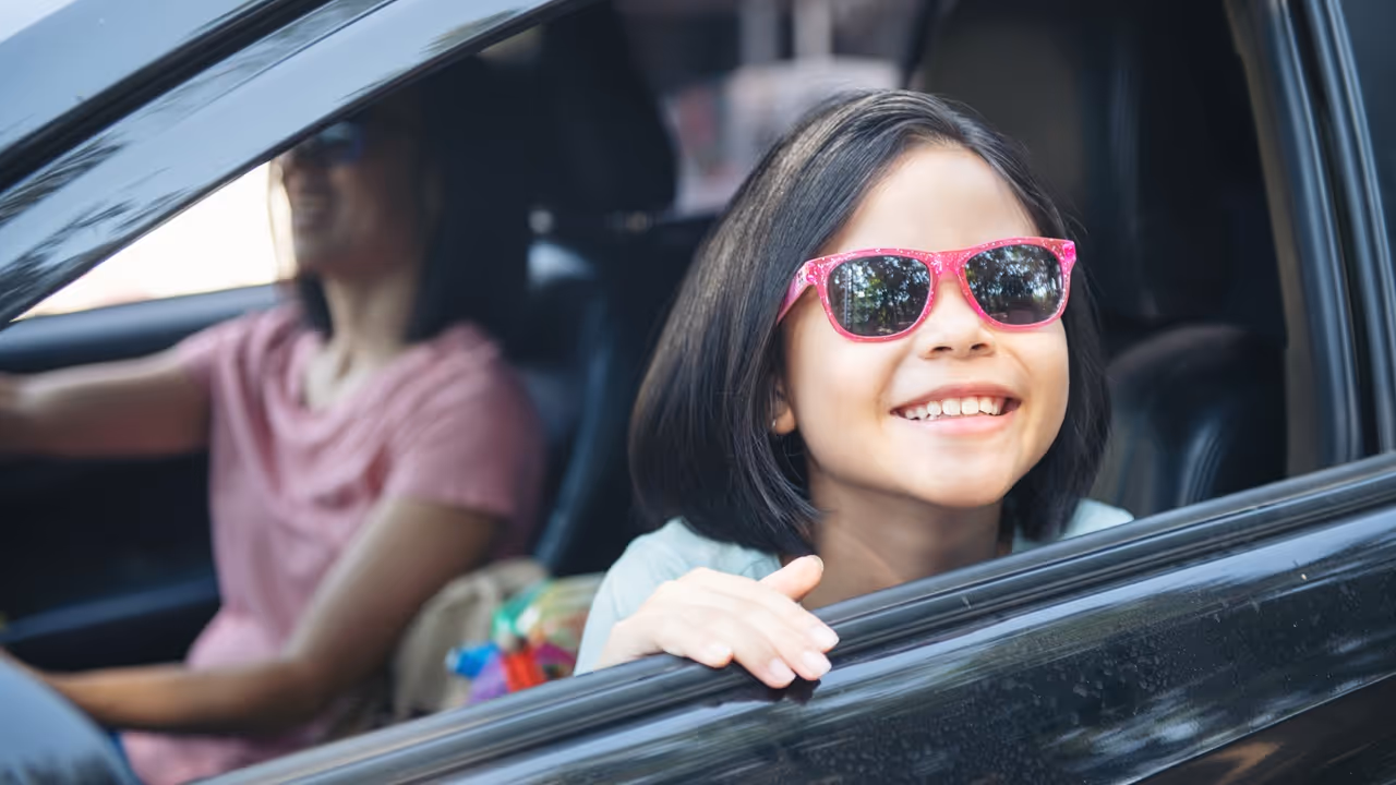 mom driving car while her daughter sitting eside mom driving car while her daughter sitting eside