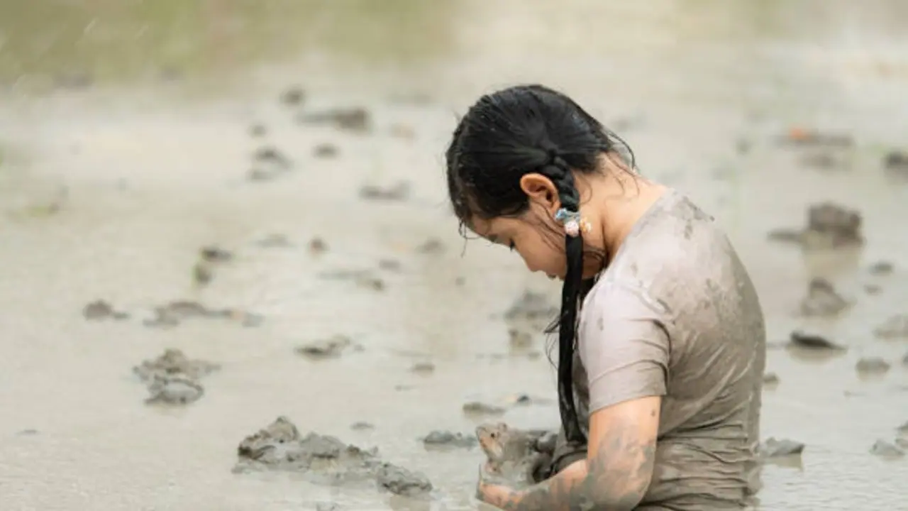 mother and child soaked in mud mother and child soaked in mud