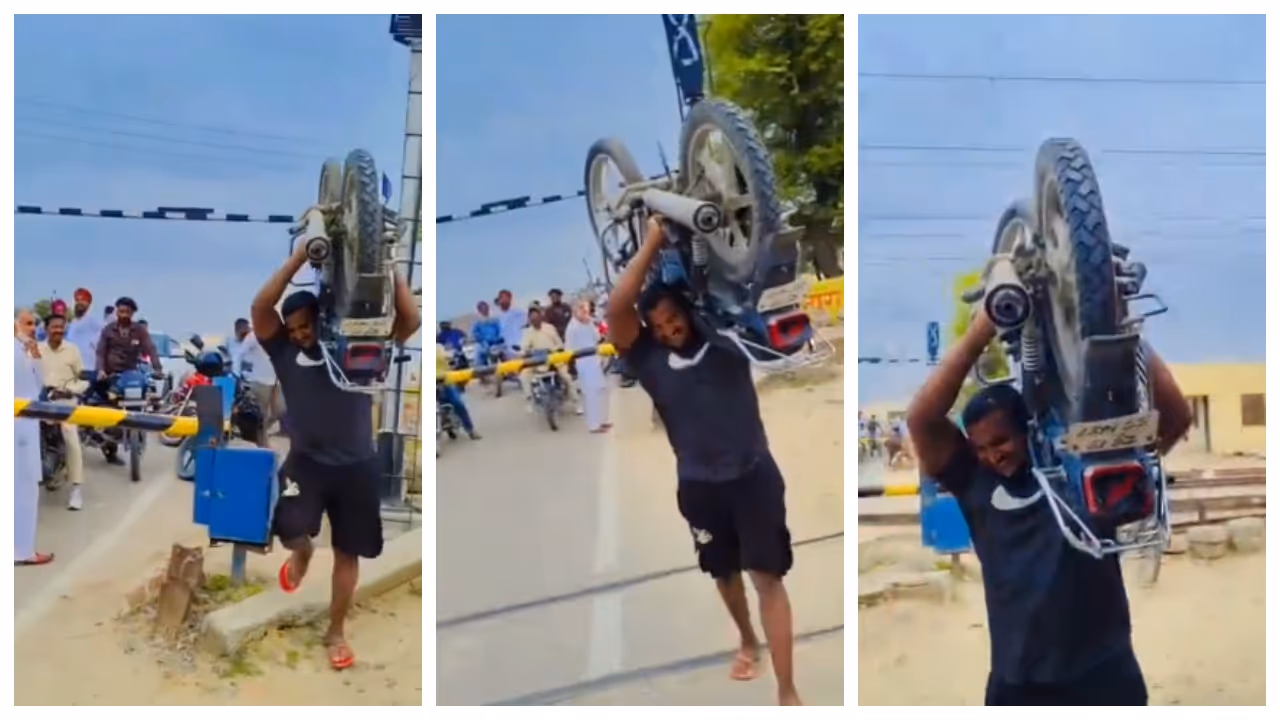 man carrying a 112 kg bike due to not having time to wait at the railway crossing