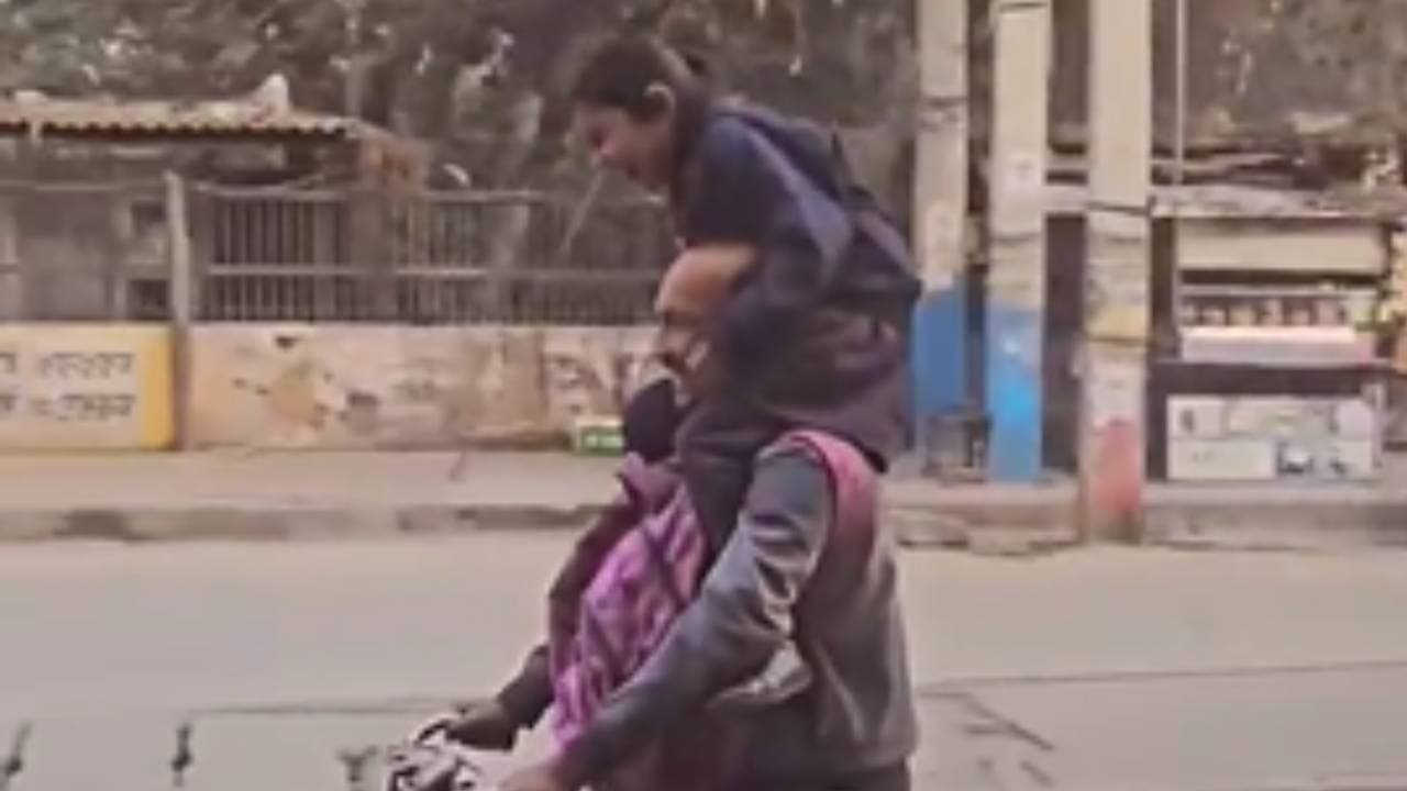 father joyfully cycles home with daughter