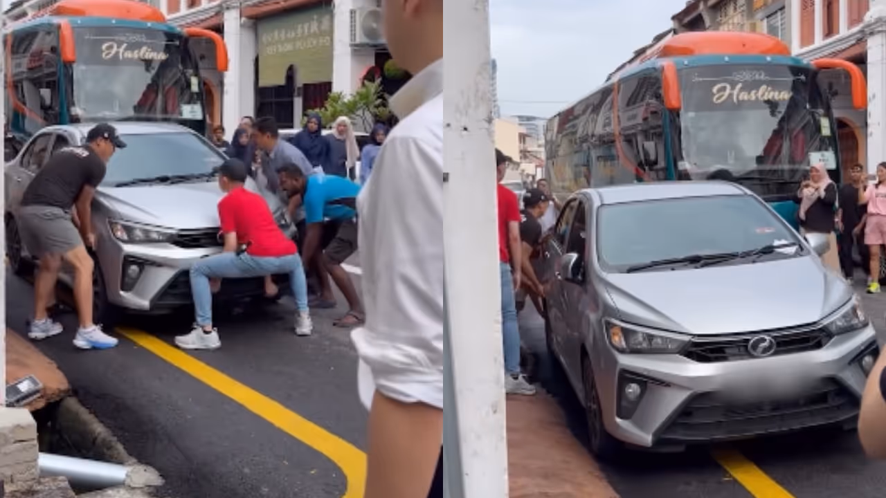 Men Lift Car Aside in Malaysia's Penang Men Lift Car Aside in Malaysia's Penang