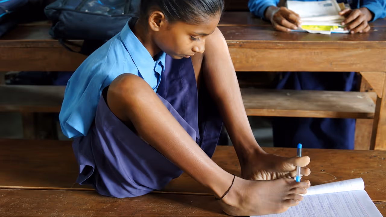 13 year old Lakshmi writes with her feet refuses to let disability stop her 13 year old Lakshmi writes with her feet refuses to let disability stop her