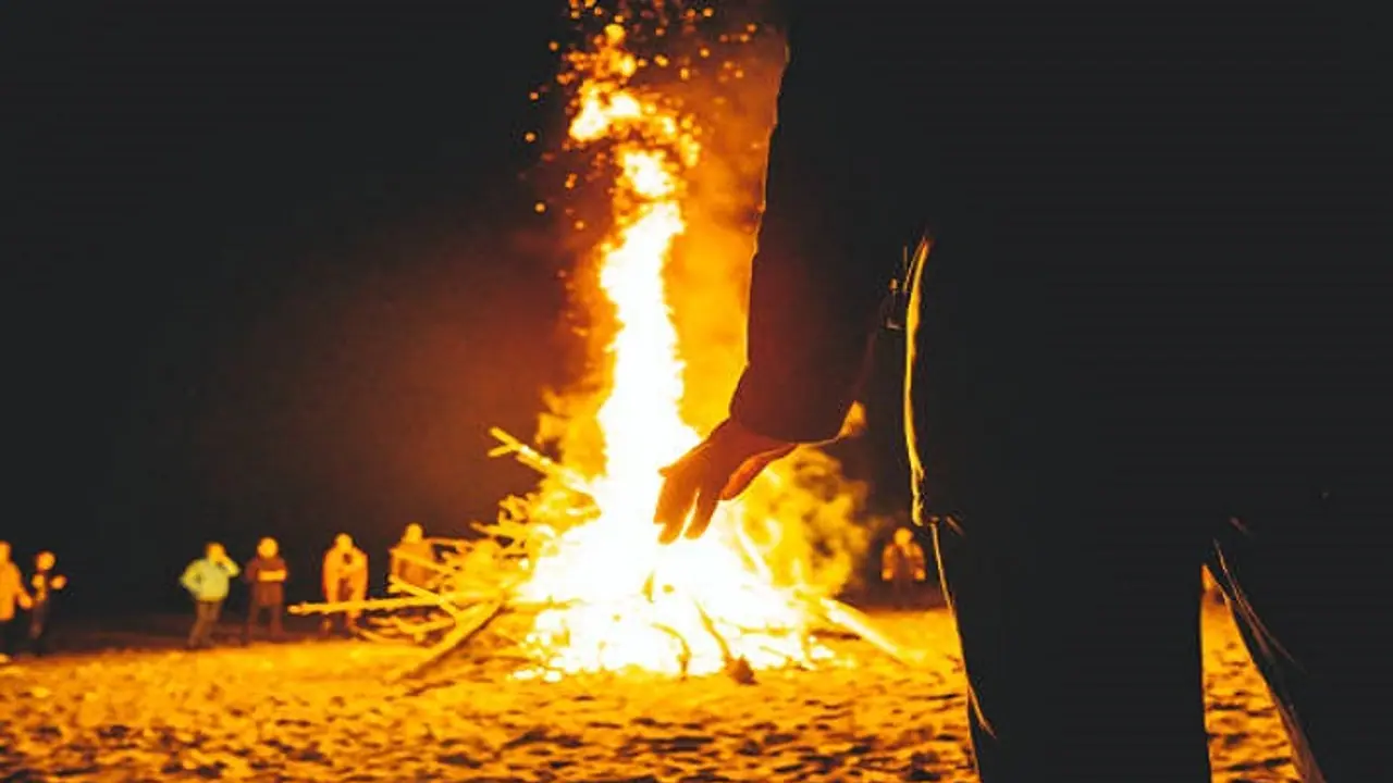young man lying on a burning pyre in grief of friend s death young man lying on a burning pyre in grief of friend s death
