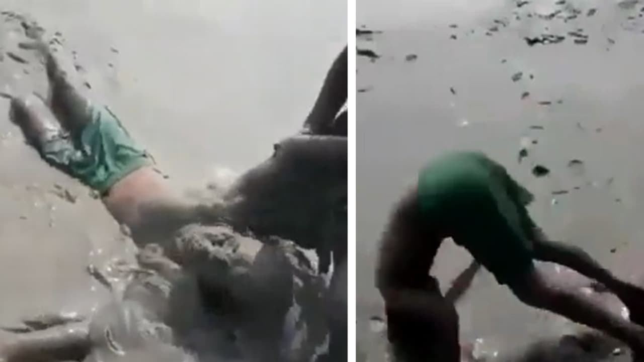 boy jumping into mud pond boy jumping into mud pond