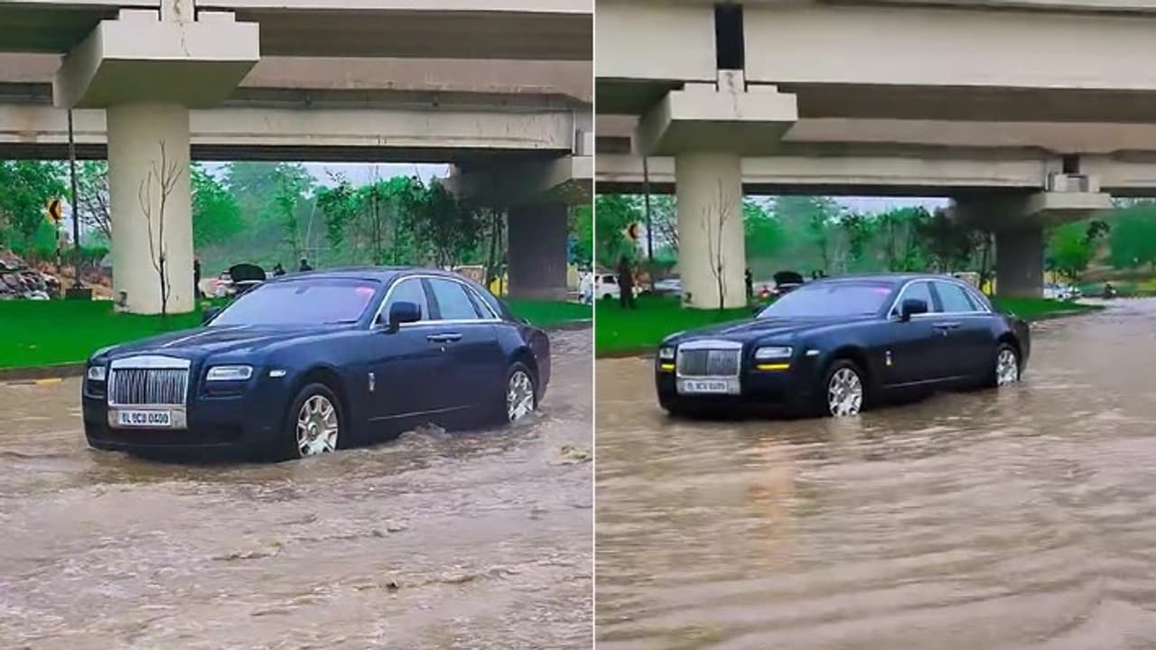 Rolls Royce Ghost on flooded road Rolls Royce Ghost on flooded road
