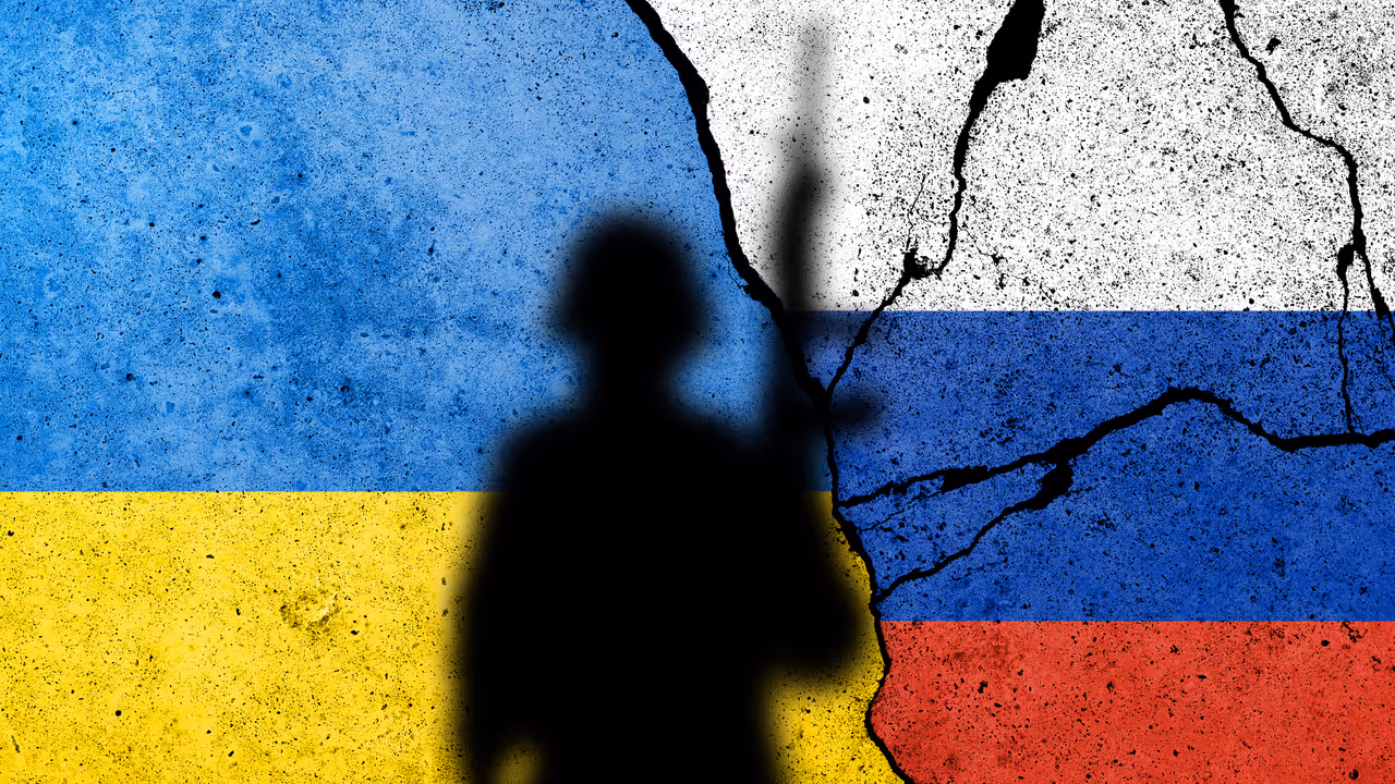 Flag of Ukraine and Russia painted on a brick wall with soldiers Flag of Ukraine and Russia painted on a brick wall with soldiers