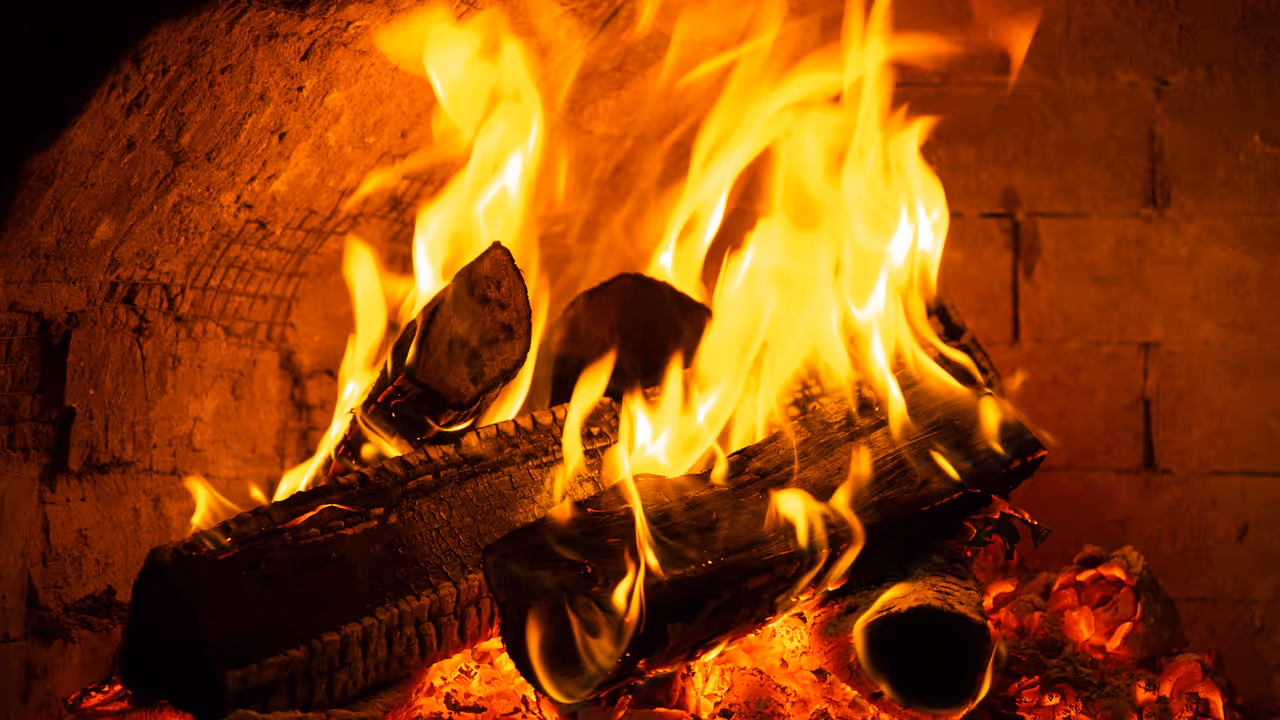 Firewood burns in traditional oven Firewood burns in traditional oven