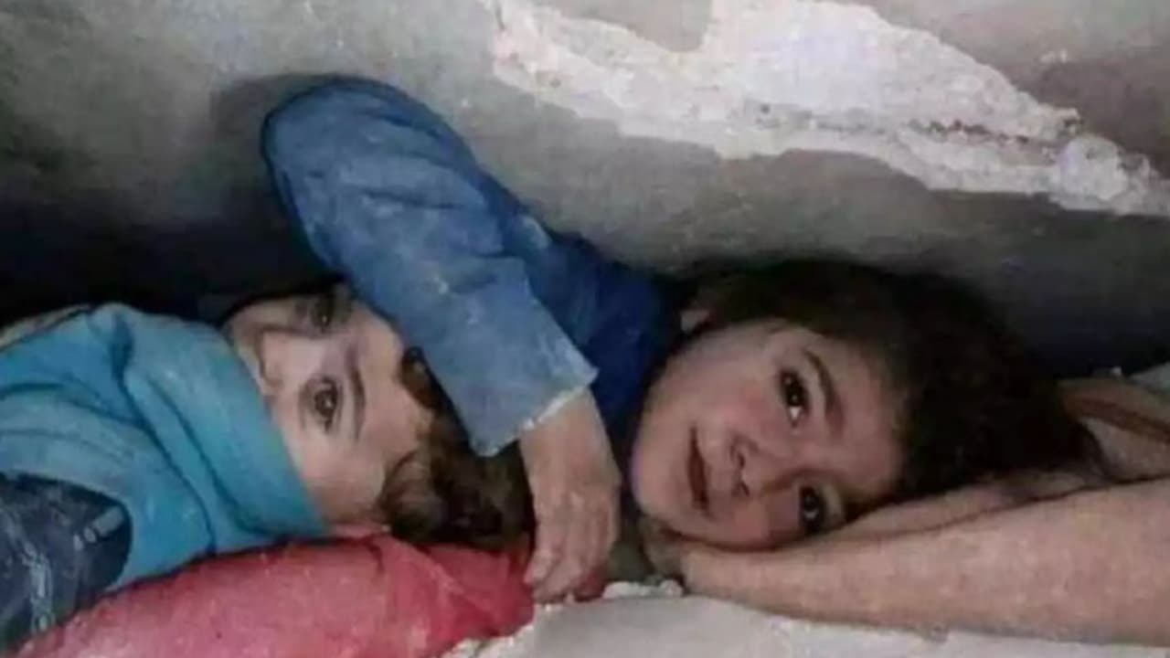 Syrian girl protecting brother 