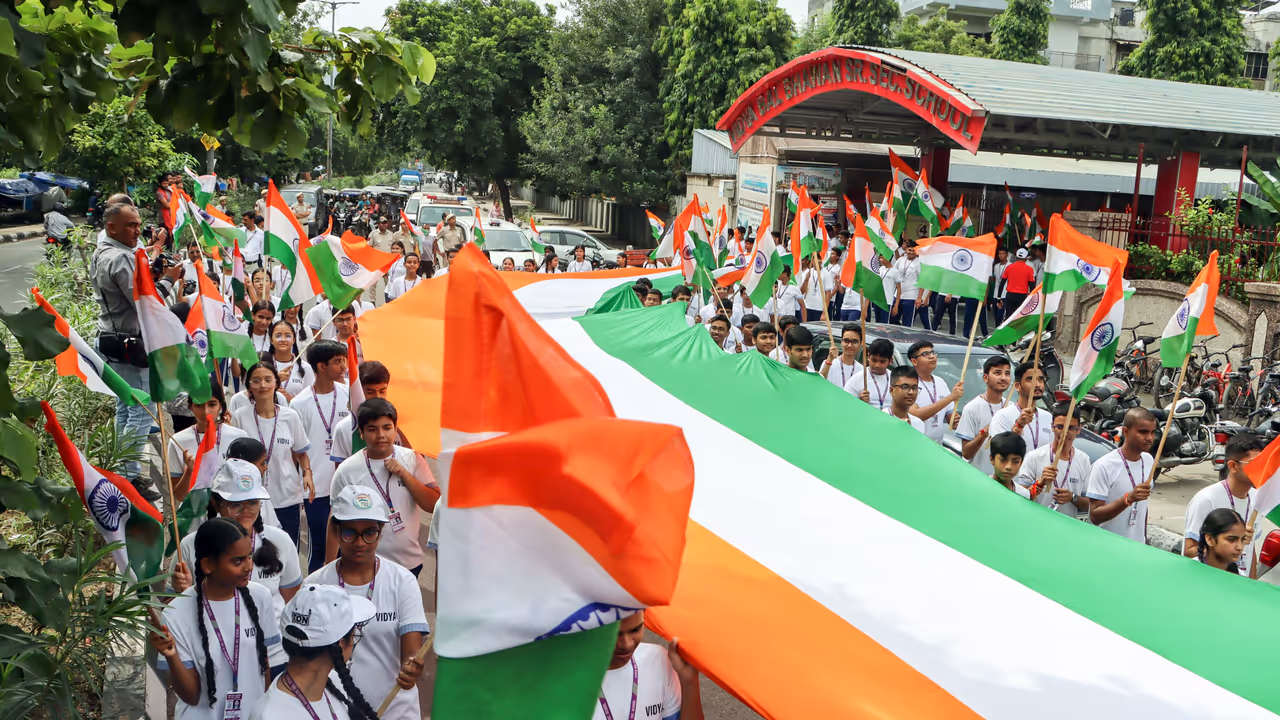 Students march with a 100 foot long tricolor flag