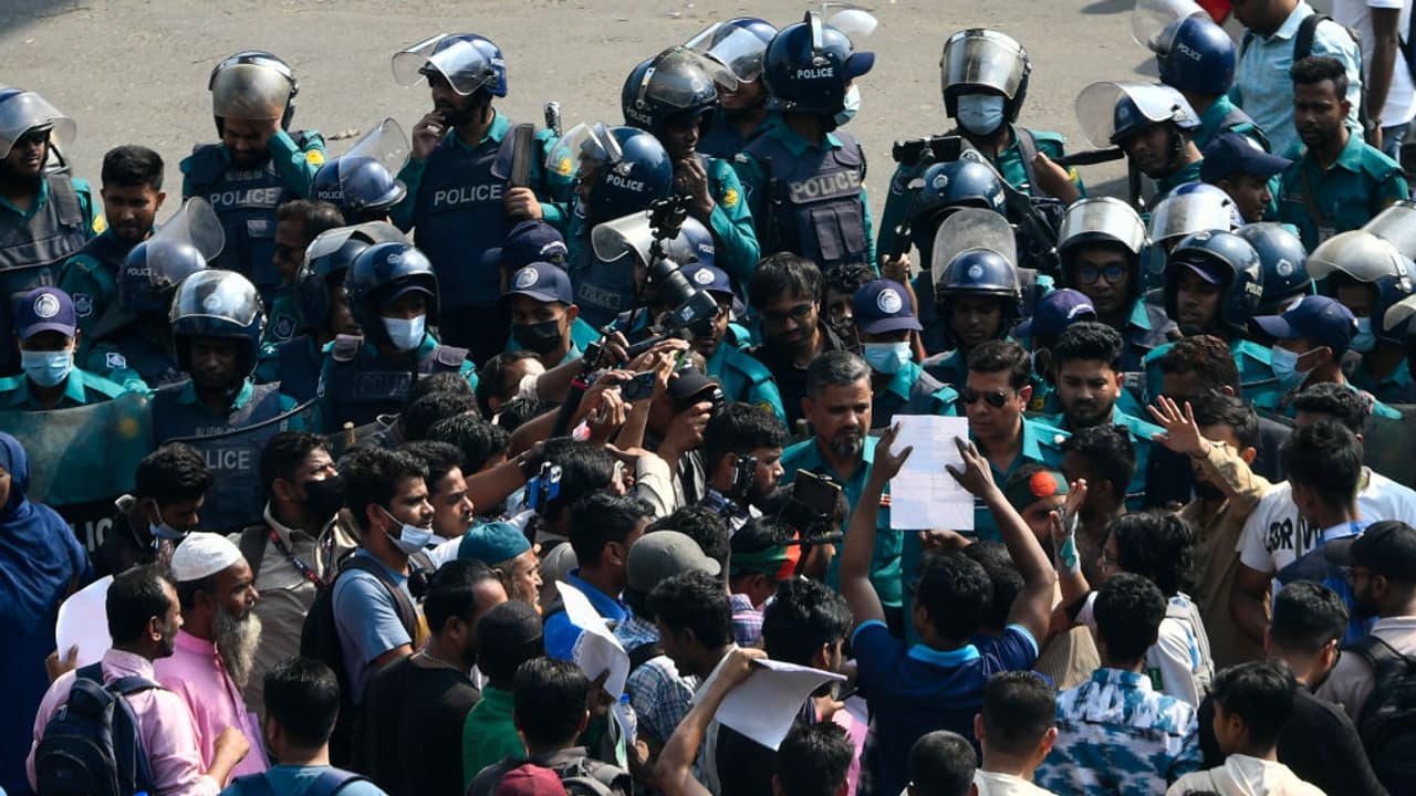 Protesters injured in the July uprising block a road at Shahbagh Square in Dhaka