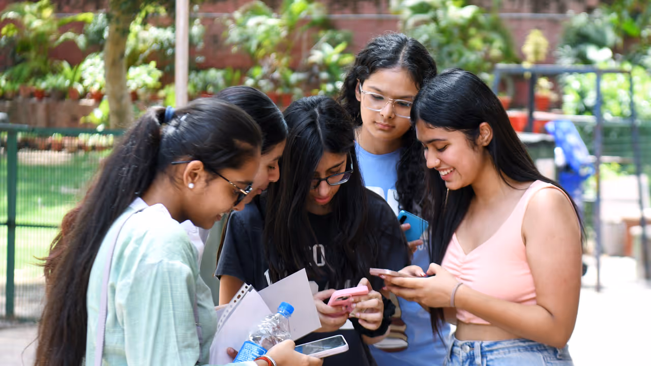 Students check their CBSE 12th board results on their mobile phones Students check their CBSE 12th board results on their mobile phones
