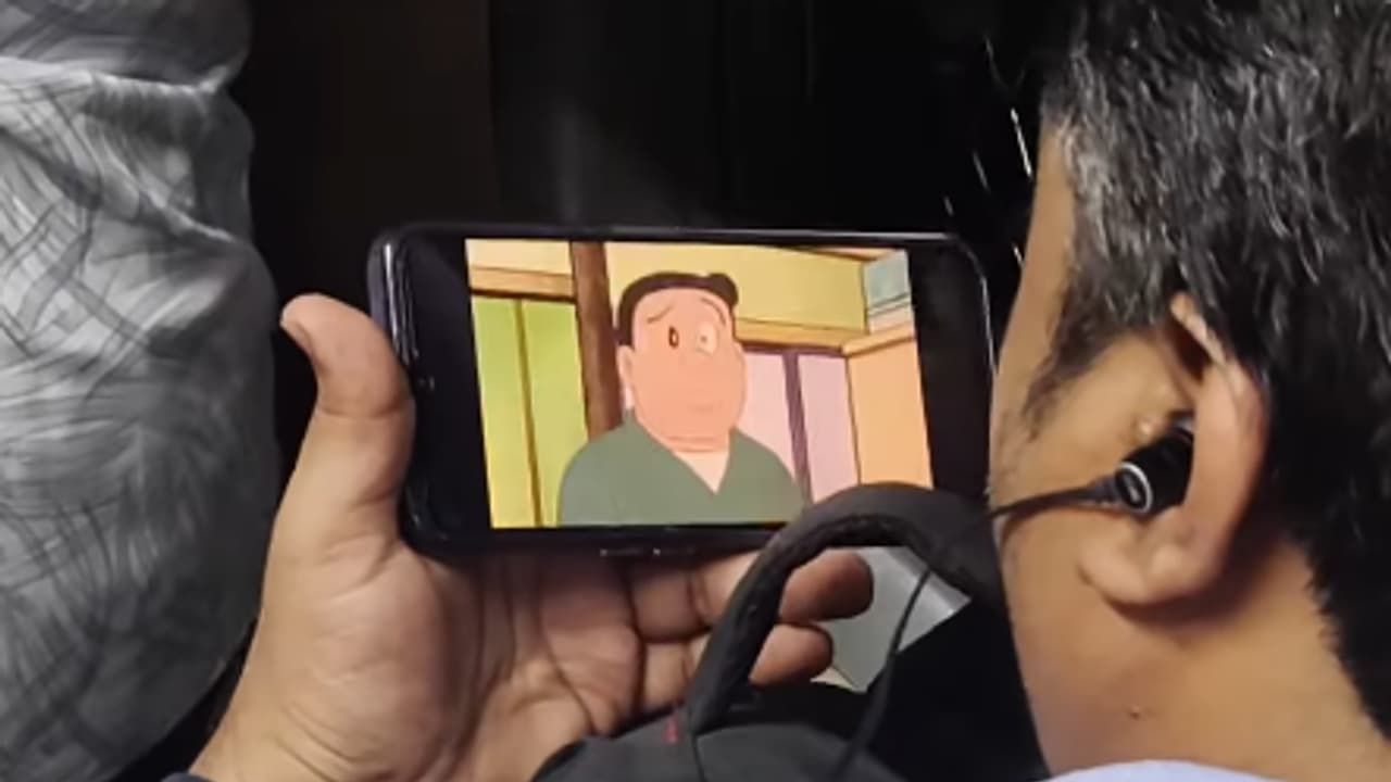 Man Watches Doraemon In Crowded Local Train Man Watches Doraemon In Crowded Local Train