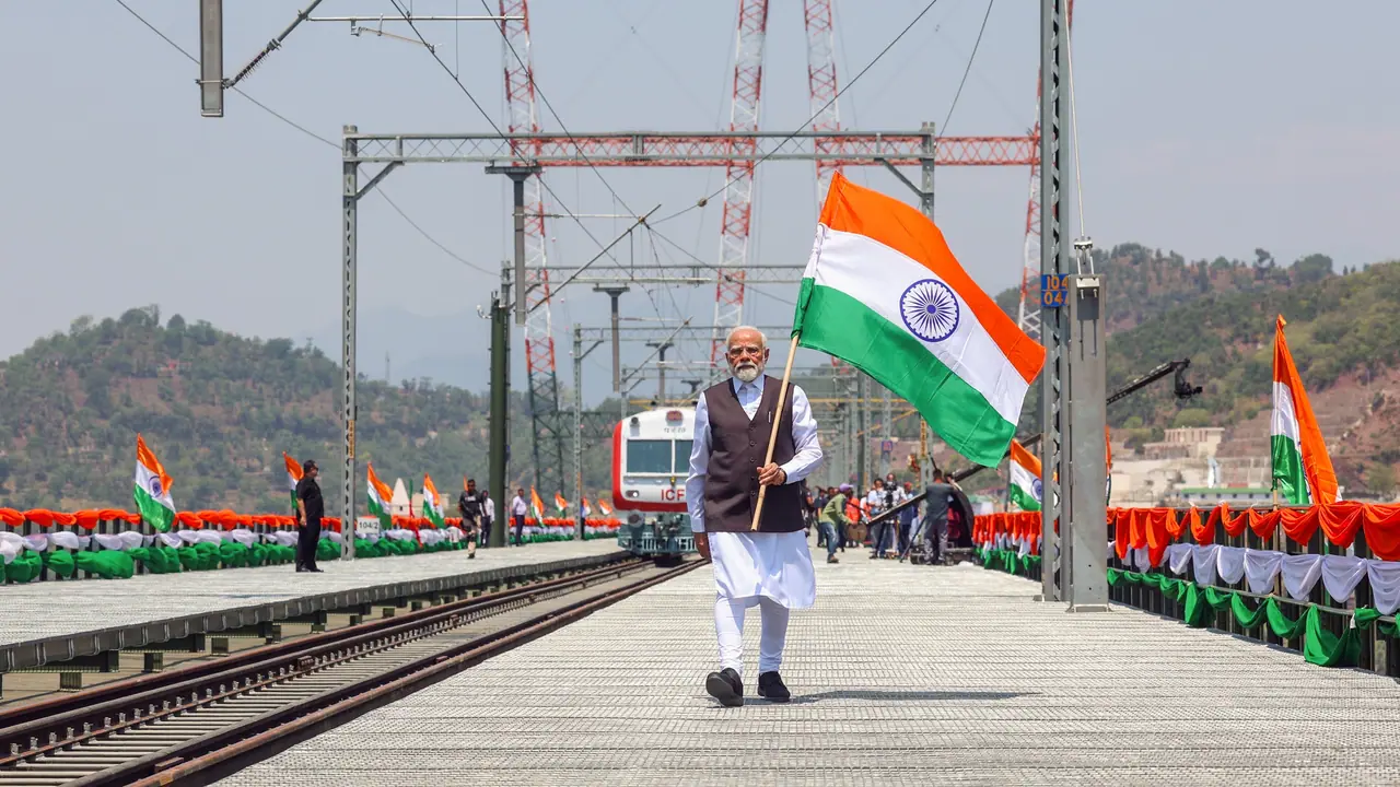 PM Modi waves the Tiranga as he inaugurates the Chenab bridge the world’s highest railway arch bridge