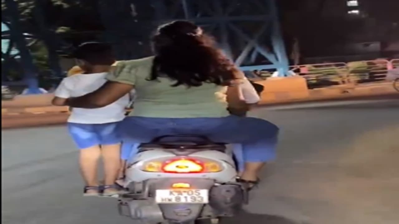 Mother Stands her child in scooter leg stand video viral on social media Mother Stands her child in scooter leg stand video viral on social media