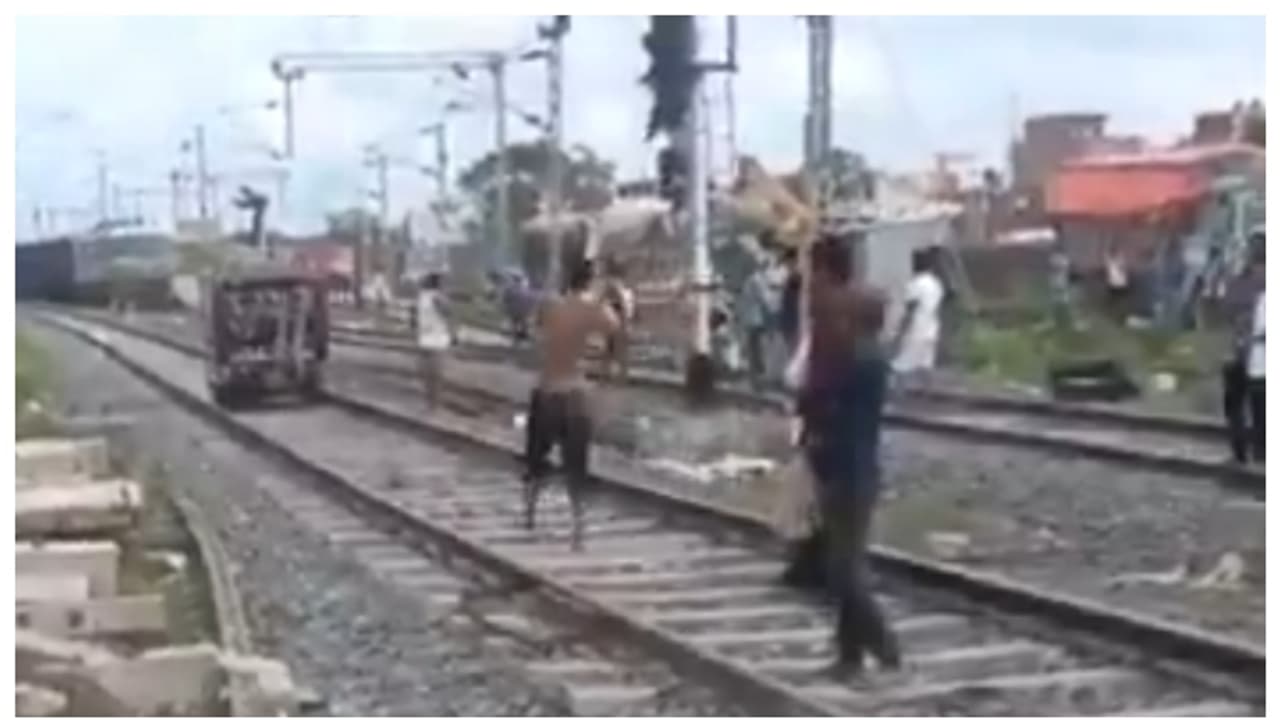 Drunk man driving an autorickshaw on the railway tracks