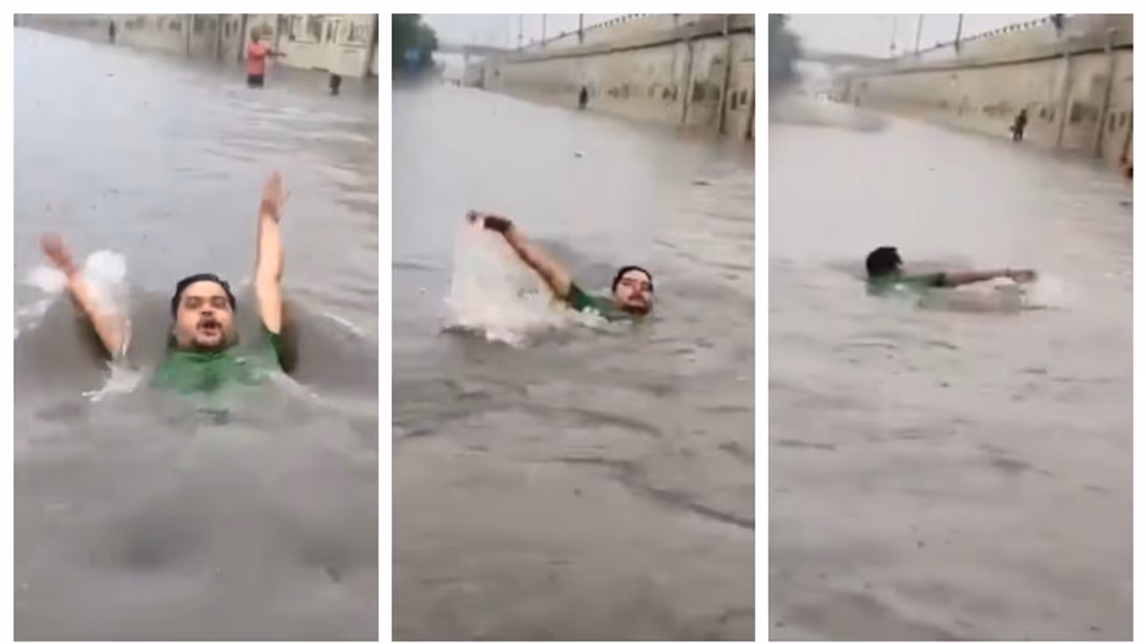 man swims through waterloagged road in delhi after heavy rain man swims through waterloagged road in delhi after heavy rain