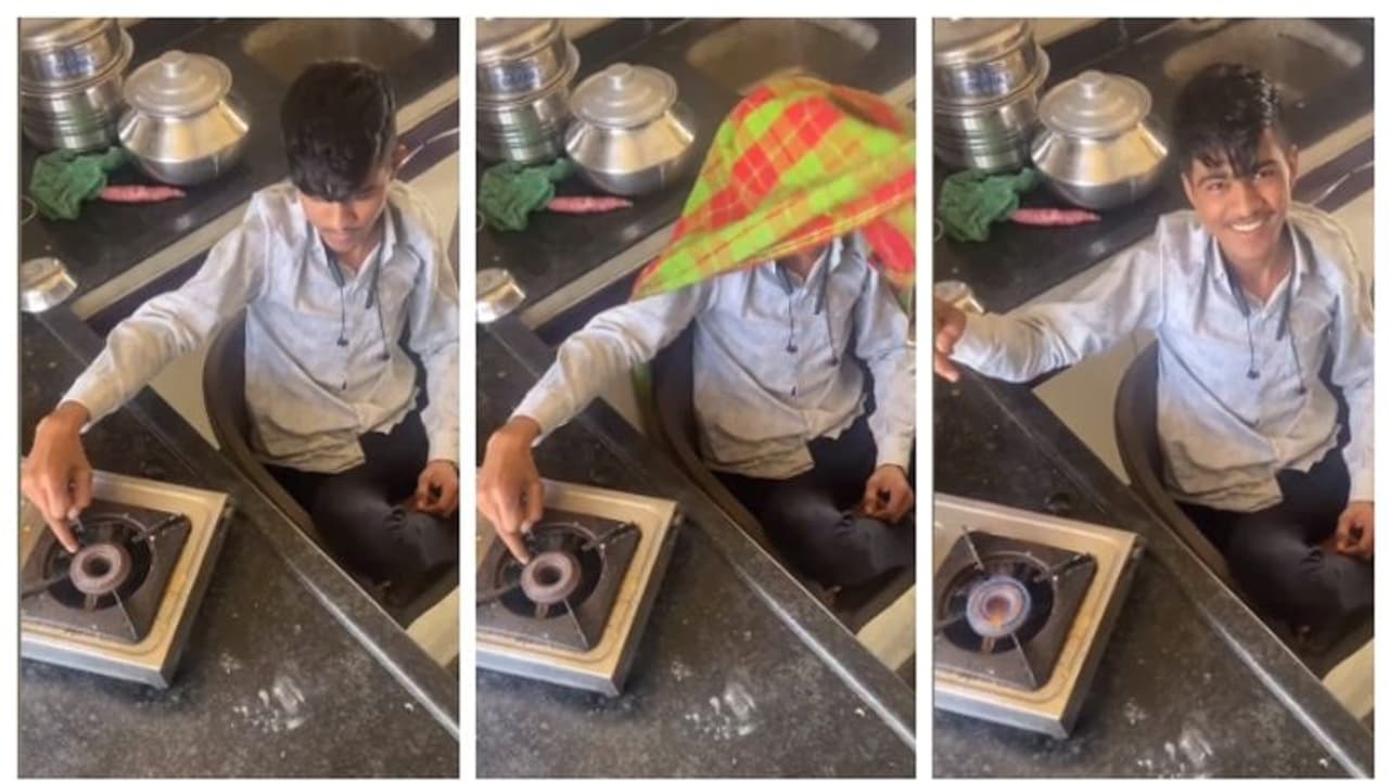 boy lighting gas stove using his finger