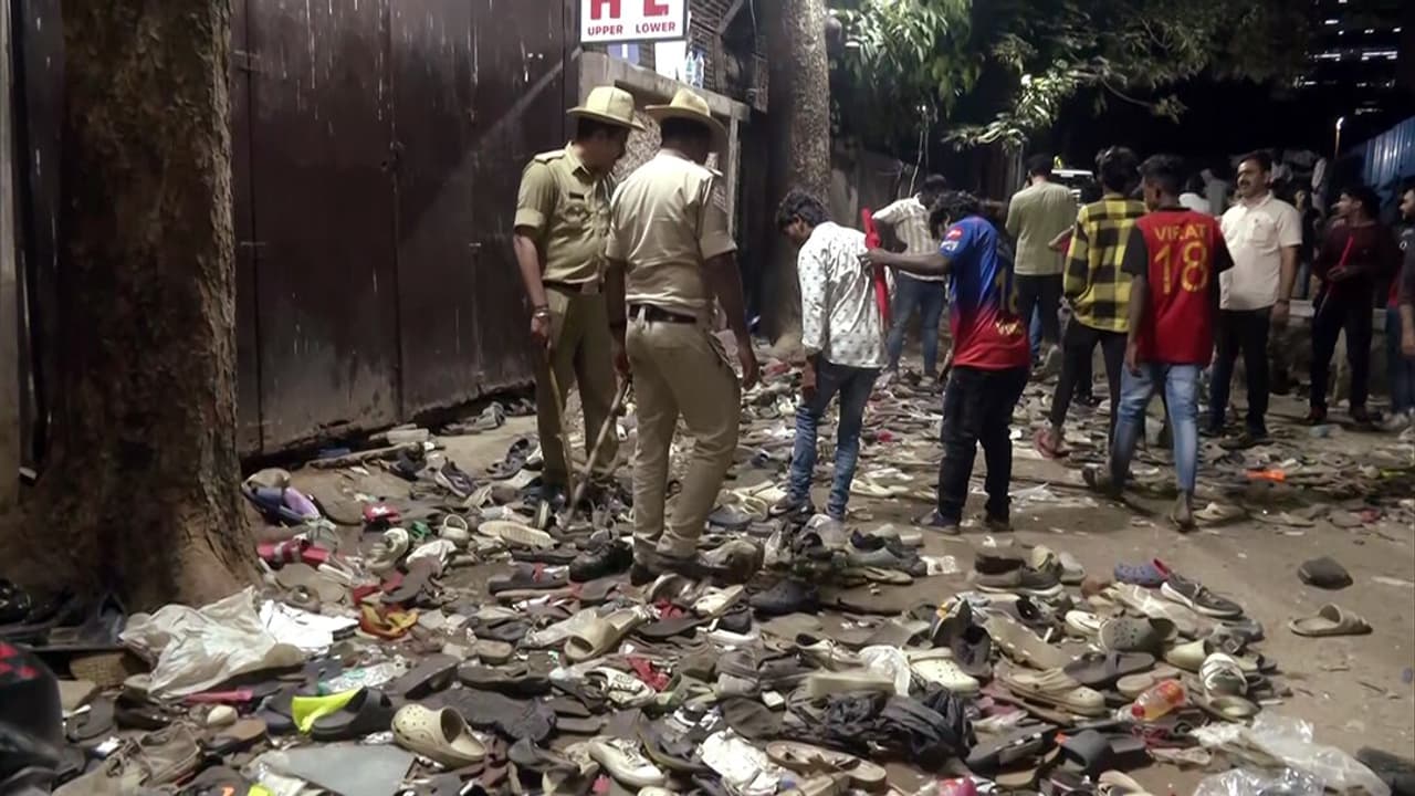 A number of shoes and slippers lying outside the Chinnaswamy Stadium after a stampede