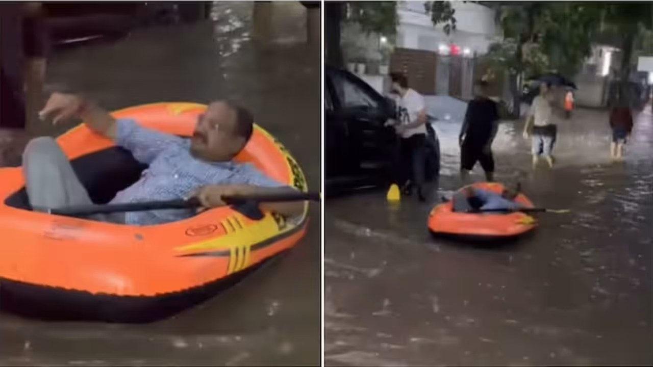 Delhi Man Rides Raft Through Flooded Road in Greater Kailash Delhi Man Rides Raft Through Flooded Road in Greater Kailash