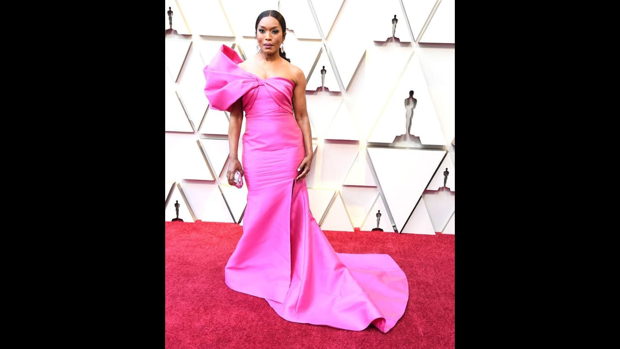 Looking pretty in pink, Angela Bassett wore a structured Reem Acra outfit for the red carpet. Looking pretty in pink, Angela Bassett wore a structured Reem Acra outfit for the red carpet.