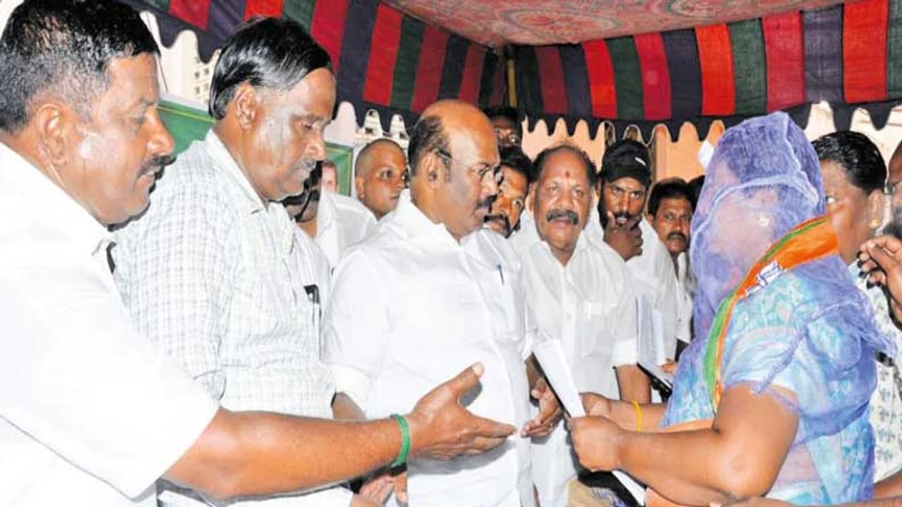 இடுப்பில் மண்சட்டி.. தலையில் கொசுவலை... அமைச்சரிடம் மனு கொடுத்து பாஜக தலைவி அதிரடி!!