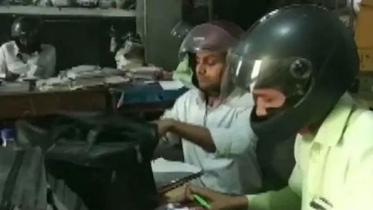 ഓഫീസിനുള്ളിൽ ഹെൽമെറ്റ് ധരിച്ച് വൈദ്യുതി വകുപ്പിലെ ഉദ്യോഗസ്ഥർ; കാരണം ഇതാണ് ഓഫീസിനുള്ളിൽ ഹെൽമെറ്റ് ധരിച്ച് വൈദ്യുതി വകുപ്പിലെ ഉദ്യോഗസ്ഥർ; കാരണം ഇതാണ്
