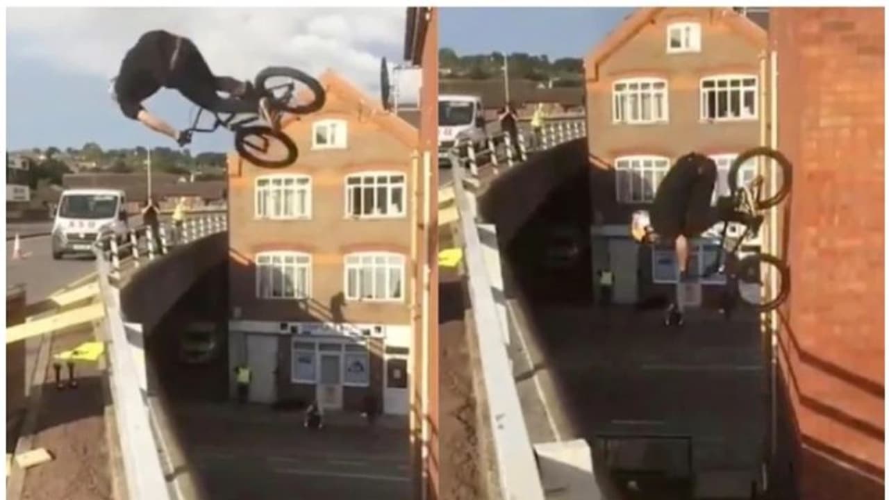 ഫ്ലൈഓവറിലെ കൈവരിക്ക് മുകളിലൂടെ ഫ്ലിപ് ചെയ്ത് കെട്ടിടത്തിന്റെ ഭിത്തിയിലേക്ക് ഇറങ്ങുന്ന സൈക്കിള്; വീഡിയോ ഫ്ലൈഓവറിലെ കൈവരിക്ക് മുകളിലൂടെ ഫ്ലിപ് ചെയ്ത് കെട്ടിടത്തിന്റെ ഭിത്തിയിലേക്ക് ഇറങ്ങുന്ന സൈക്കിള്; വീഡിയോ