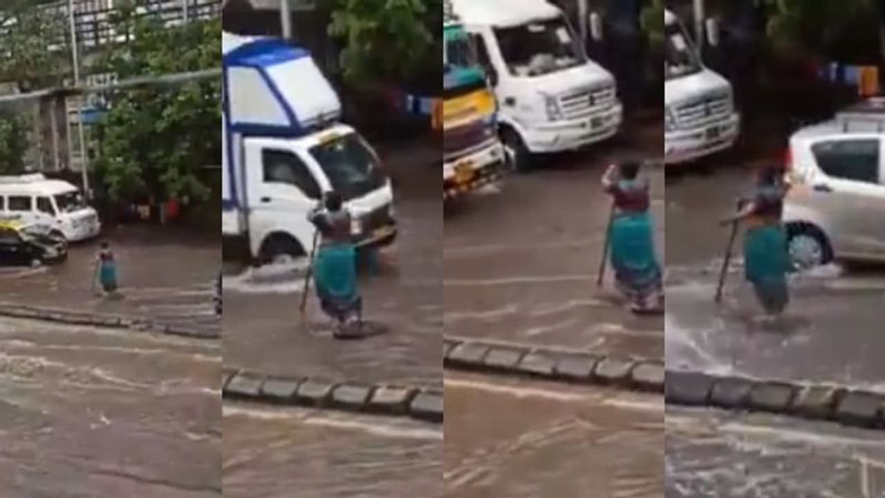 തുറന്നുകിടന്ന മാന്‍ഹോളില്‍ ആരും വീഴാതിരിക്കാന്‍ മഴ നനഞ്ഞുകൊണ്ട് സ്ത്രീ നിന്നത് മണിക്കൂറുകള്‍ വീഡിയോ