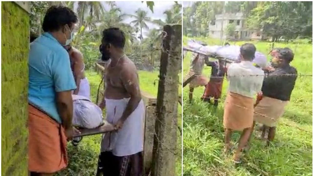 വീട്ടിലേക്ക് വഴിയില്ല, കമ്പിവേലിക്ക് മുകളിലൂടെ മൃതദേഹം പുറത്തെത്തിക്കാൻ പെടാപ്പാട് പെട്ട് നാട്ടുകാർ വീട്ടിലേക്ക് വഴിയില്ല, കമ്പിവേലിക്ക് മുകളിലൂടെ മൃതദേഹം പുറത്തെത്തിക്കാൻ പെടാപ്പാട് പെട്ട് നാട്ടുകാർ