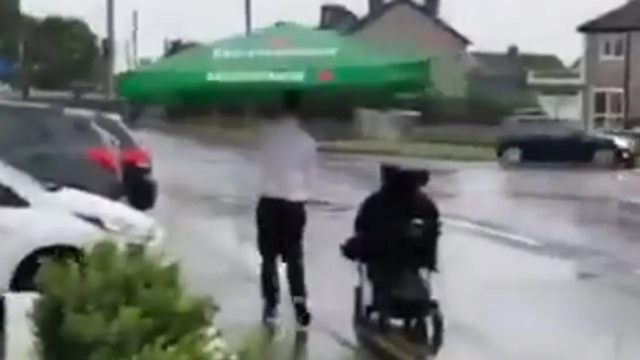 Cafe worker helps patron who uses a wheelchair in heavy rain; Watch Viral Video
