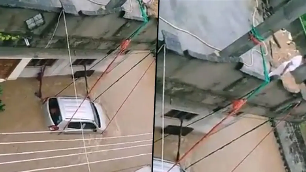 Man ties car with ropes to prevent from being washed away; watch video Man ties car with ropes to prevent from being washed away; watch video