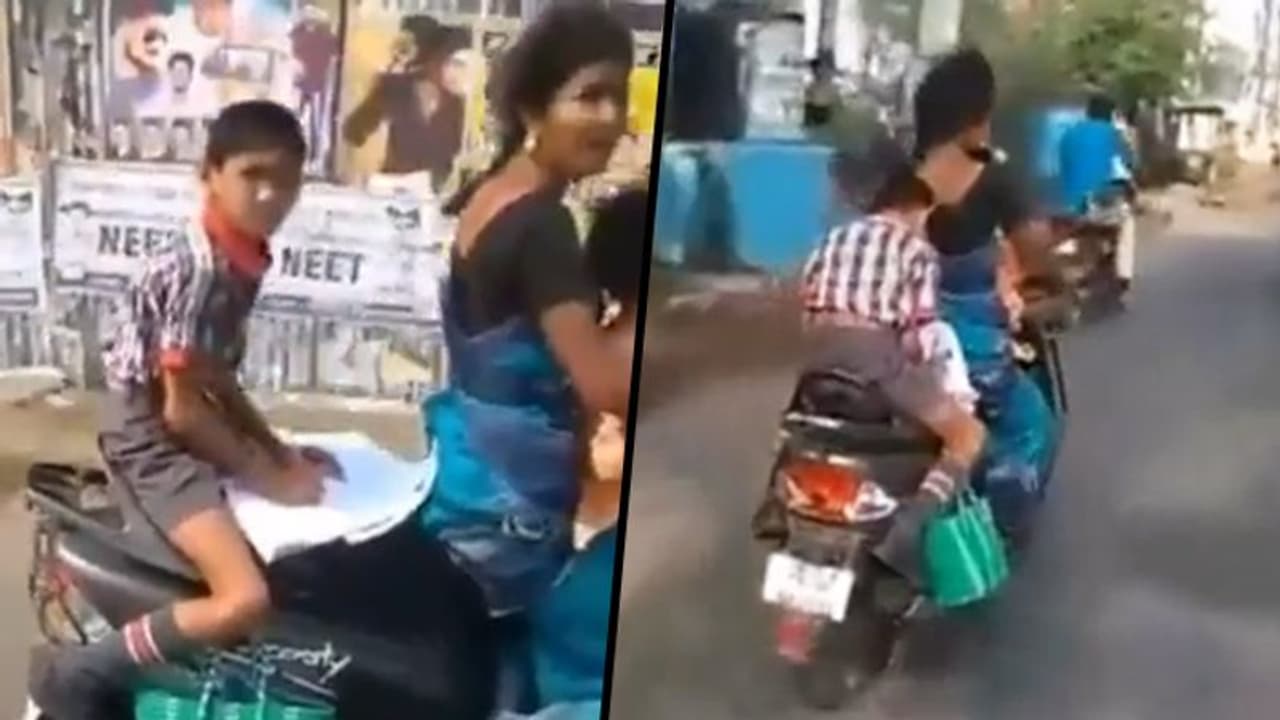 Watch: Student completes homework on scooter's backseat on his way to school; viral video Watch: Student completes homework on scooter's backseat on his way to school; viral video