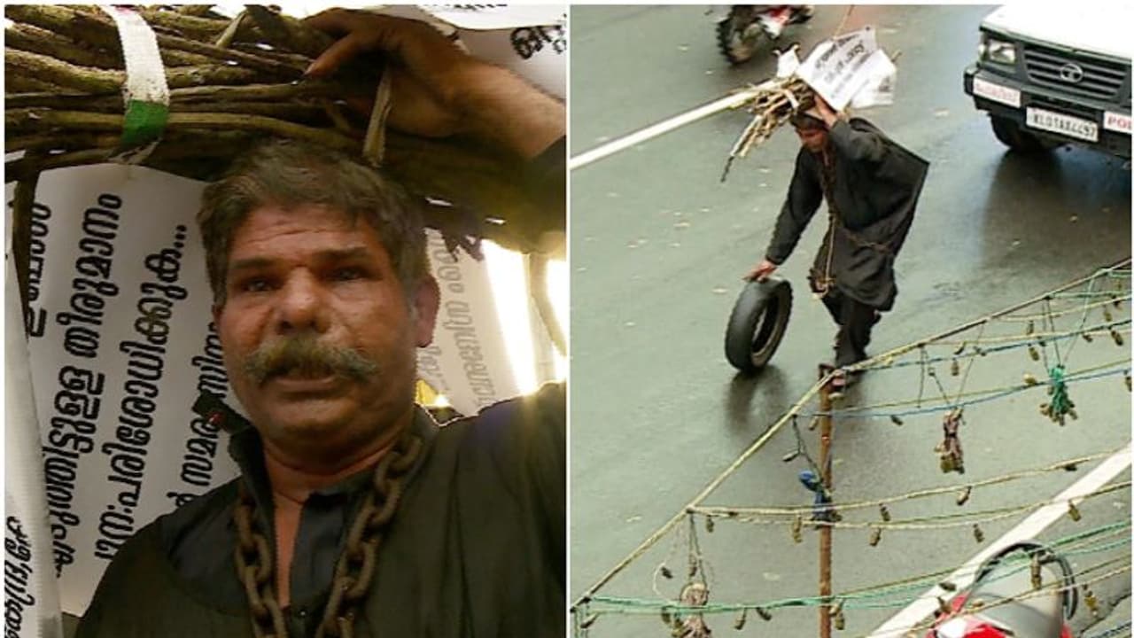 ഇന്ധന വില: പെടാപ്പാട് പെടുന്ന കര്ഷകന്റെ പ്രതിഷേധം; കറുപ്പുടുത്ത് ചങ്ങലയാൽ ബന്ധിച്ച് ചക്രമുരുട്ടി തങ്കച്ചൻ ഇന്ധന വില: പെടാപ്പാട് പെടുന്ന കര്ഷകന്റെ പ്രതിഷേധം; കറുപ്പുടുത്ത് ചങ്ങലയാൽ ബന്ധിച്ച് ചക്രമുരുട്ടി തങ്കച്ചൻ