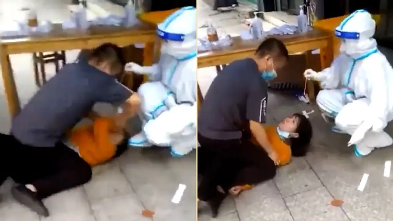 Watch:Chinese woman pinned down on floor for forced Covid 19 test Watch:Chinese woman pinned down on floor for forced Covid 19 test