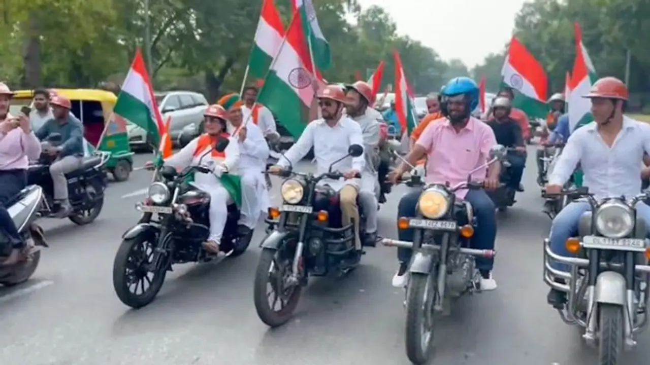 MPs take part in a Tiranga bike rally starting from Red Fort to Parliament