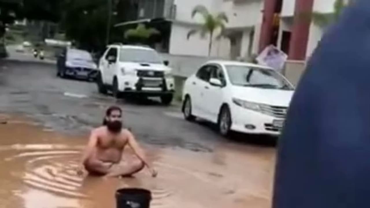 குண்டும் குழியுமான சாலை… நூதன முறையில் இளைஞர் போராட்டம்… வைரலாகும் வீடியோ!! குண்டும் குழியுமான சாலை… நூதன முறையில் இளைஞர் போராட்டம்… வைரலாகும் வீடியோ!!