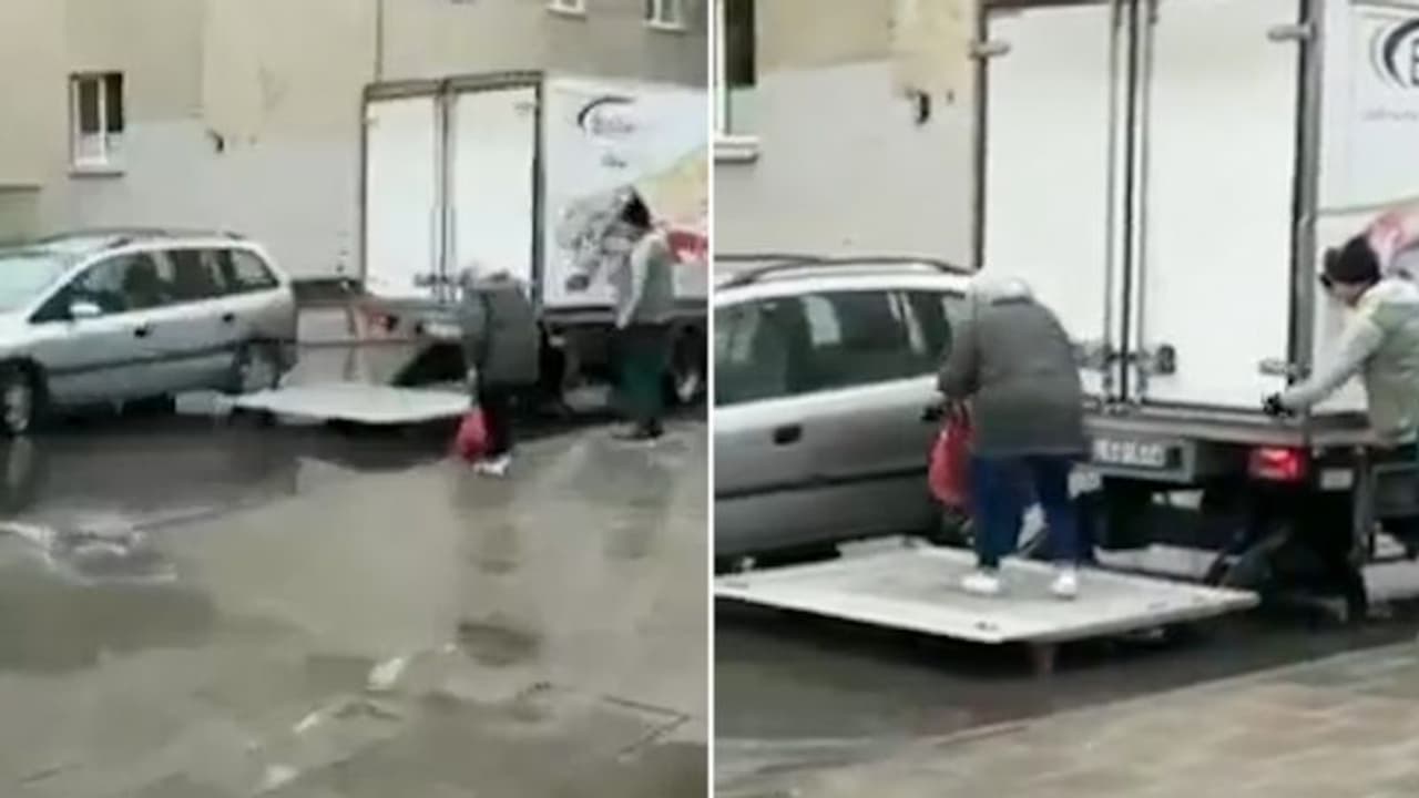 Watch: Truck driver helping elderly woman cross waterlogged street wins internet hearts