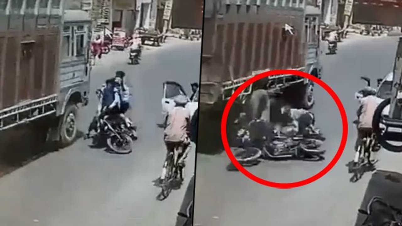 Bikers colliding into a moving truck shows why one should carefully open car's door; watch video here Bikers colliding into a moving truck shows why one should carefully open car's door; watch video here