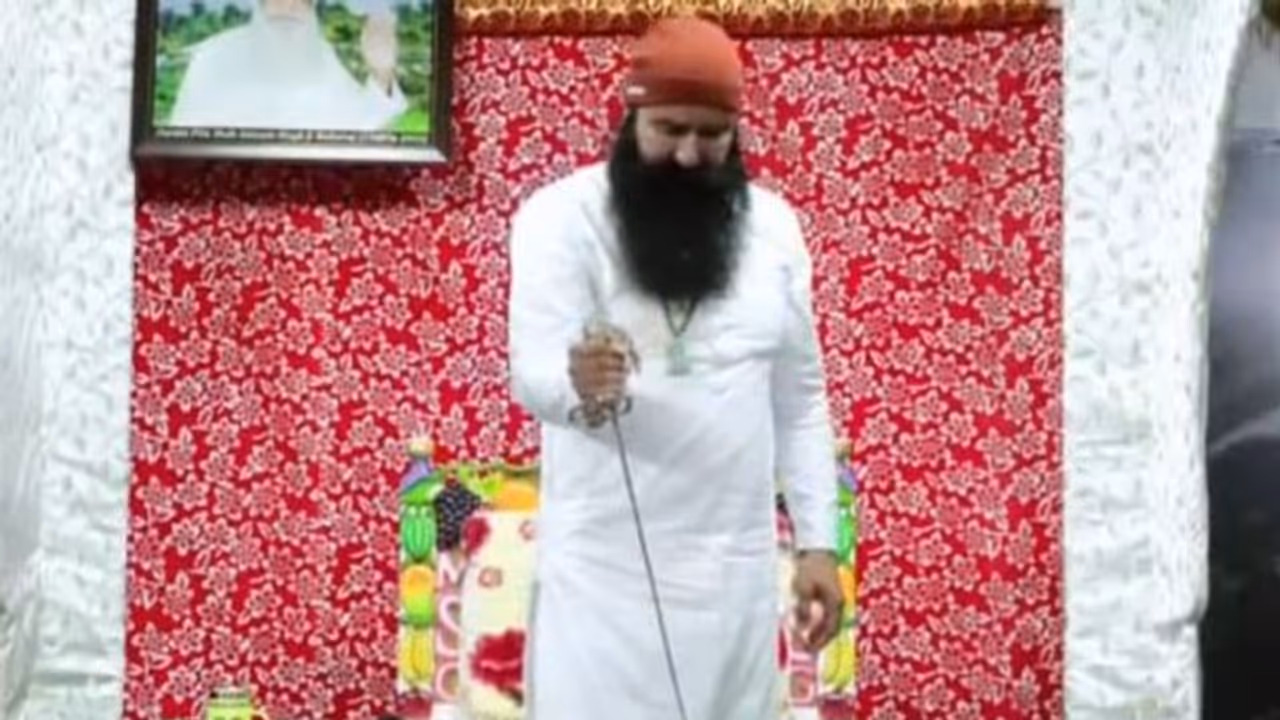 Out on parole, Dera Sacha Sauda chief Gurmeet Ram Rahim cuts cake with sword; check viral video Out on parole, Dera Sacha Sauda chief Gurmeet Ram Rahim cuts cake with sword; check viral video