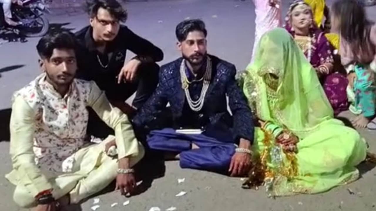 bride and groom sitting on dharna bride and groom sitting on dharna