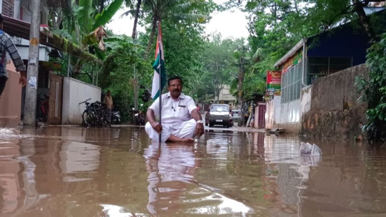 മാര്‍ച്ച് 24 മന്ത്രി ഉദ്ഘാടനം ചെയ്ത റോഡില്‍ വെള്ളക്കെട്ടിന് പരിഹാരമായില്ല, ചെളിയില്‍ ഇരുന്ന് പ്രതിഷേധം