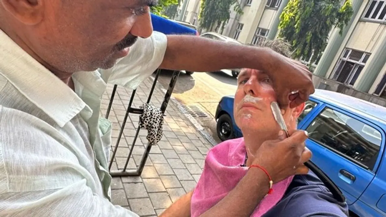 Michael Vaughan, former England cricket captain, gets a haircut and shave at Mumbai's roadside barber (WATCH)