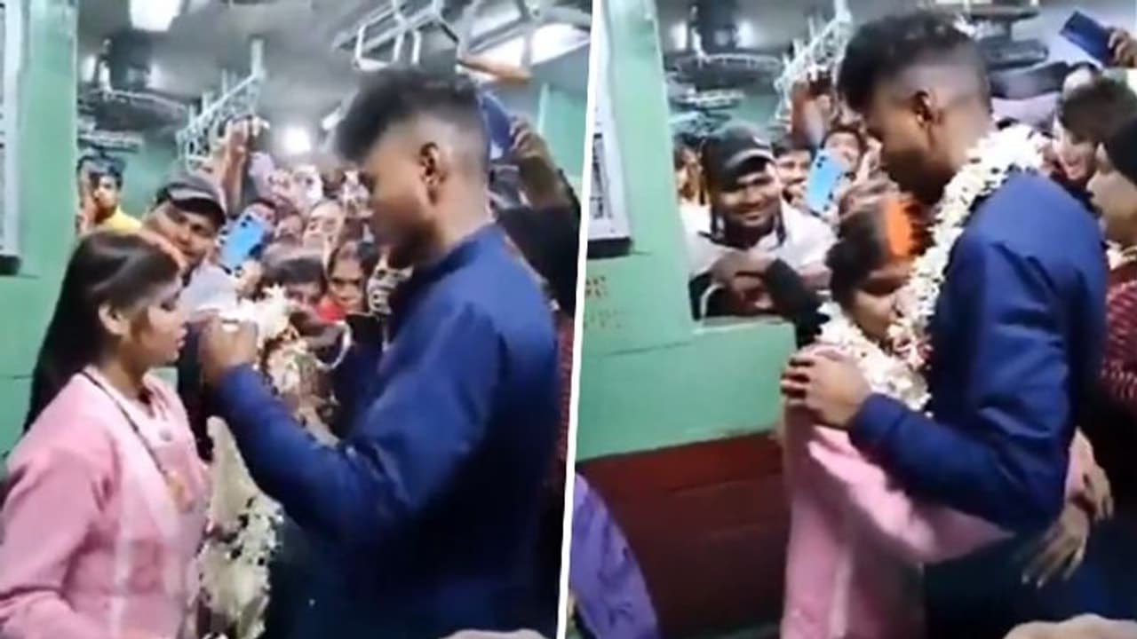 Viral Video: Couple exchange garlands, groom ties mangalsutra around bride's neck in moving train wedding Viral Video: Couple exchange garlands, groom ties mangalsutra around bride's neck in moving train wedding