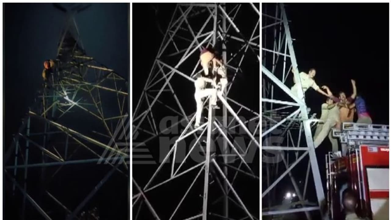 കയ്യിൽ പെട്രോളുമായി വൈദ്യുതി ടവറിൽ കയറി യുവാവ്; ഭാര്യ എത്തിയിട്ടും രക്ഷയില്ല, കാമുകിയെ കാണണമെന്ന് പിടിവാശി കയ്യിൽ പെട്രോളുമായി വൈദ്യുതി ടവറിൽ കയറി യുവാവ്; ഭാര്യ എത്തിയിട്ടും രക്ഷയില്ല, കാമുകിയെ കാണണമെന്ന് പിടിവാശി