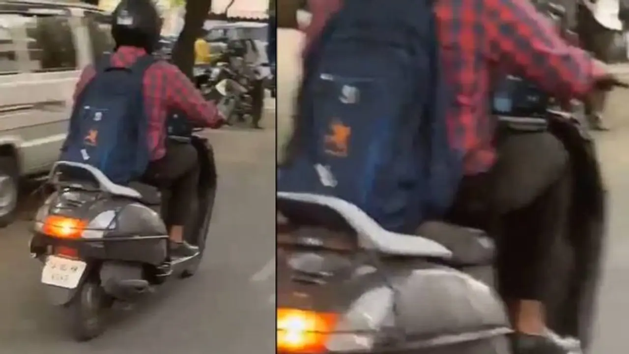 സ്കൂട്ടറോടിക്കുന്ന യുവാവിന്റെ മടിയിൽ തുറന്നുവച്ച ലാപ്ടോപ്പിൽ സൂം മീറ്റിം​ഗ്, വീഡിയോ കണ്ടമ്പരന്ന് നെറ്റിസൺസ്