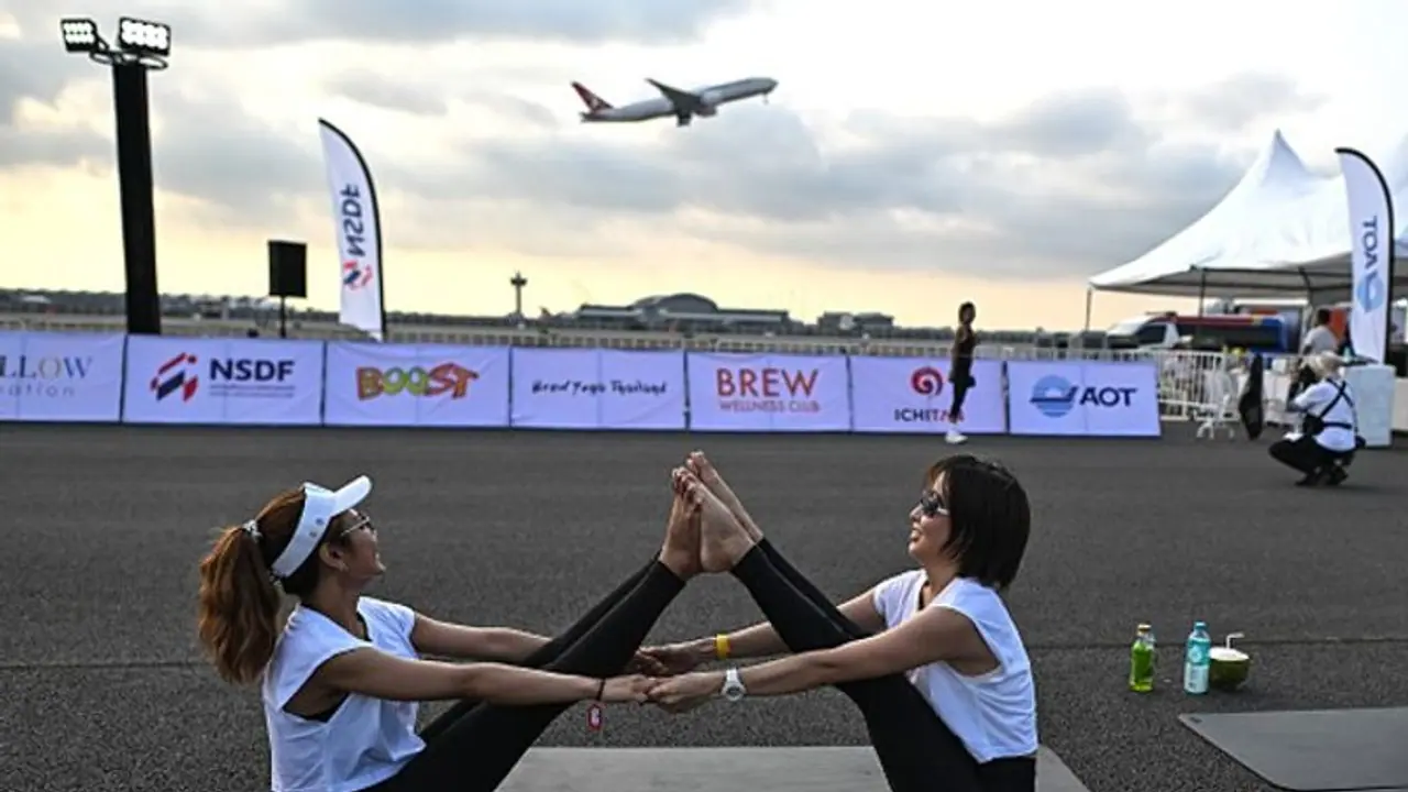 Yogis take flight! Hundreds of people perform yoga on runway of Bangkok's main airport (WATCH)