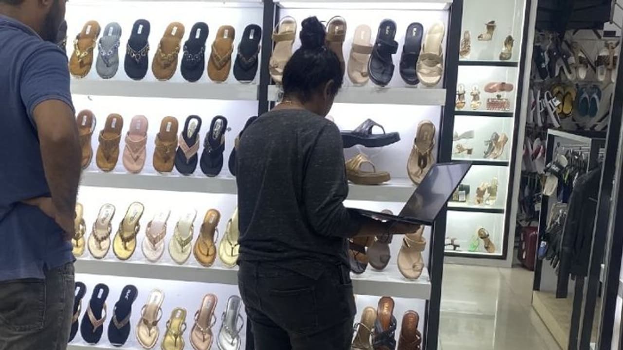 Bengaluru: Viral photo shows woman attending team meeting on laptop while shoe shopping, Internet reacts