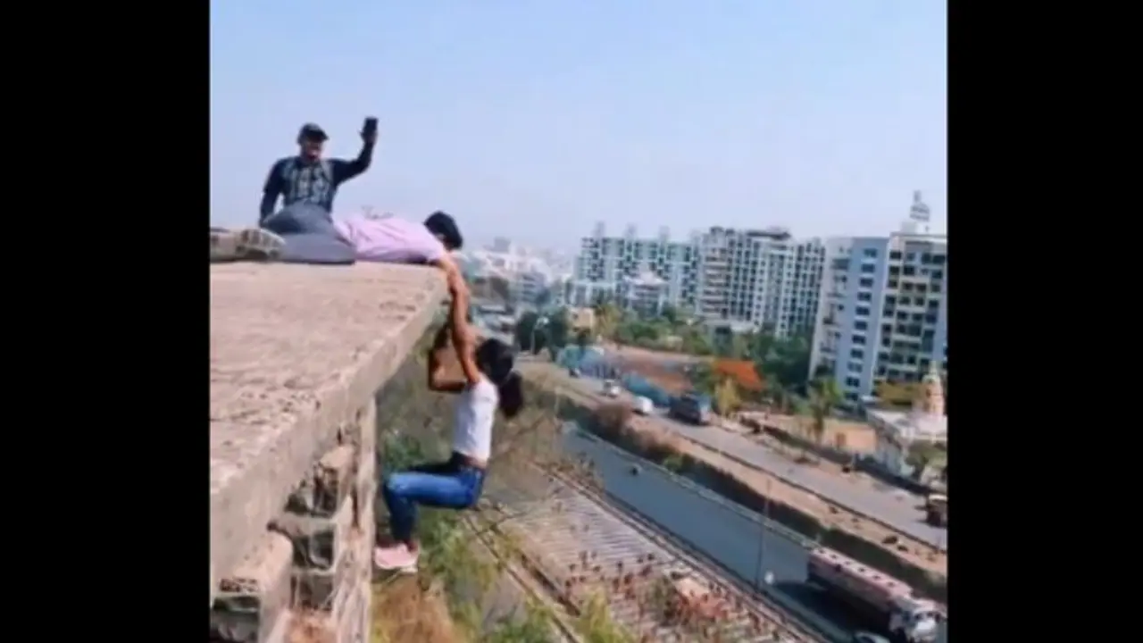 Viral Video Captures Girl Dangling from Edge of Building [WATCH]