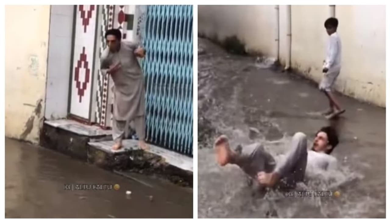 വെള്ളം ചവിട്ടാതെ റോഡ് മുറിച്ച് കടക്കാനായി ചാടി, പക്ഷേ, നടുവുംതല്ലി നടുറോഡില്‍; വീഡിയോ വൈറല്‍ 